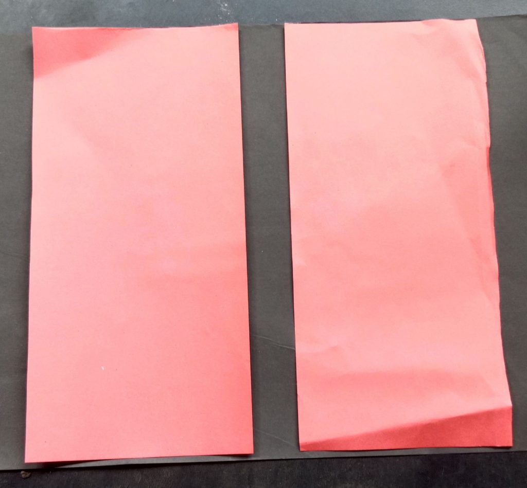 take a paper and cut through it to make two